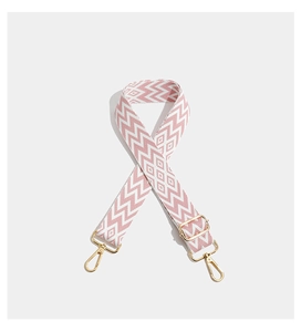 Detail of adjustable pink and white geometric woven strap with gold metal lobster clasps
