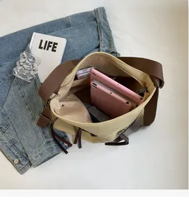 Interior view of beige canvas tote bag showing large capacity for tablets and zip pocket