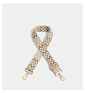 Macro detail of the bohemian geometric embroidery and polished gold metal buckles