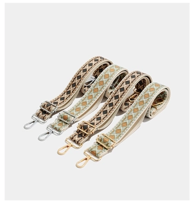 Detail of adjustable bohemian embroidered bag straps with silver and gold metal lobster clasps