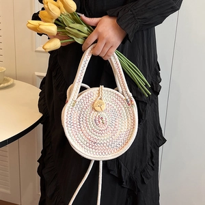 Mini circular woven straw crossbody bag with colorful wavy patterns and wooden button