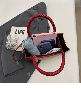 Interior view showing the large capacity of a red bridal handbag with personal items