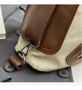 Detail of high-quality metallic hooks and canvas strap on a luxury travel tote bag