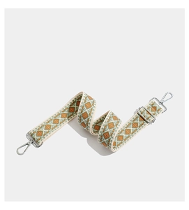 Detail of bohemian geometric embroidered bag strap with silver metal swivel hooks