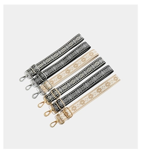 Detail view of colorful bohemian embroidered straps with durable metal clips