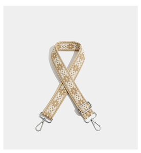 Detail of adjustable geometric embroidery bag strap with silver metal lobster clasps