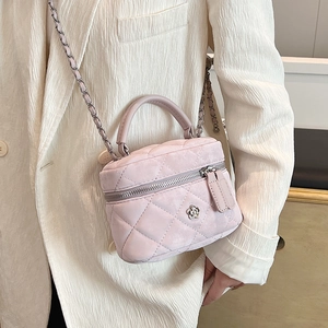 Quilted light pink mini box bag with chain strap and flower metal buckle accessory