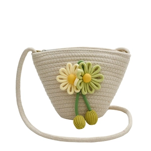 Handmade woven straw bucket bag with floral accents and strap for summer beach vacation