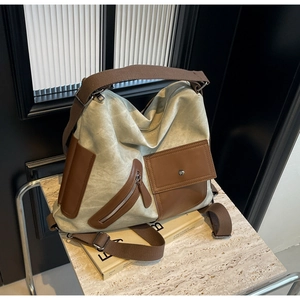 Detail of the high-capacity canvas and leather tote bag with functional utility pockets