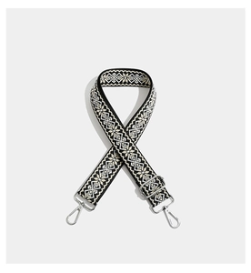 Detail of bohemian geometric embroidered wide strap with silver metal swivel hooks