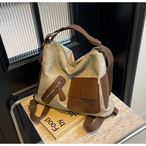 Macro shot of large canvas travel backpack with brown leather accents and zipper pockets
