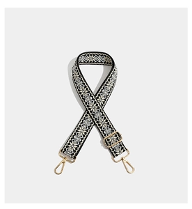 Close-up of geometric embroidered wide strap with light gold metal lobster clasp