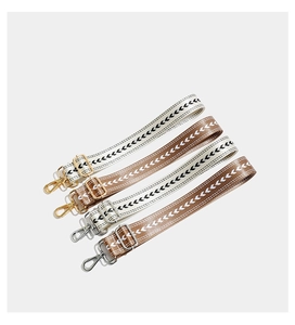 Detail of bohemian geometric embroidered wide straps with high-quality metal swivel hooks