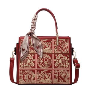 Elegant red bridal handbag with golden lotus embroidery and decorative silk scarf wrap