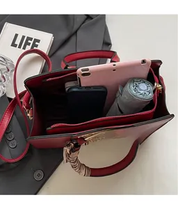 Spacious red and beige leather tote bag showing large capacity for tablet and essentials