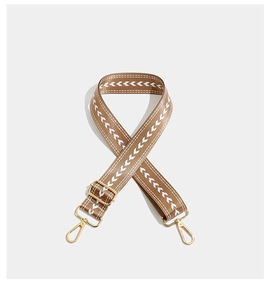 Detail of embroidered geometric pattern and golden lobster clasps on adjustable strap
