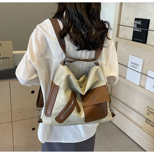 Detail of canvas tote backpack with leather trim and multi-pocket storage design