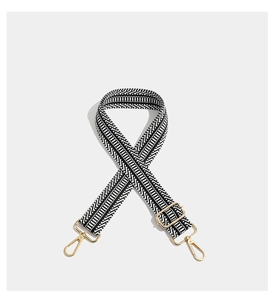 Detail of adjustable geometric strap with high-density weave and polished gold hardware