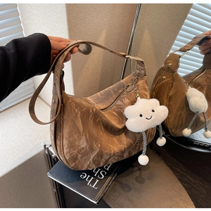 Brown dumpling bag with wrinkled texture and cute white cloud charm detail