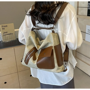 Lifestyle view of large canvas tote bag with leather trim and wide straps for travel