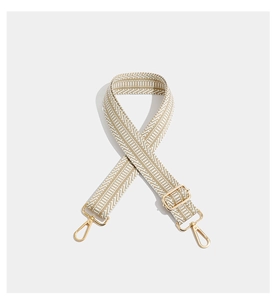 Detail of bohemian geometric embroidered wide strap with gold-tone lobster clasps