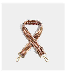 Detailed view of bohemian geometric woven strap with gold metal lobster clasps