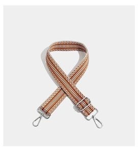 Close-up of brown and white geometric woven strap with silver metal lobster clasps