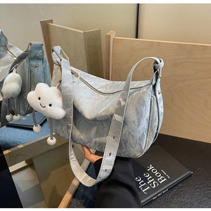Detailed texture of light blue marbled shoulder bag with cute cloud plush charm