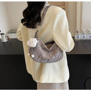 Detailed view of grey hobo bag with pleated texture and cute white cloud charm