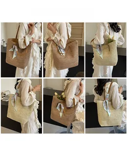 Detail view of woven straw tote bags in beige and brown with decorative silk scarf handles