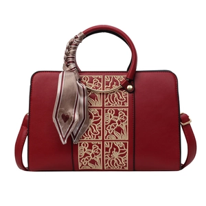 Elegant red wedding handbag with floral embroidery and decorative silk scarf handle
