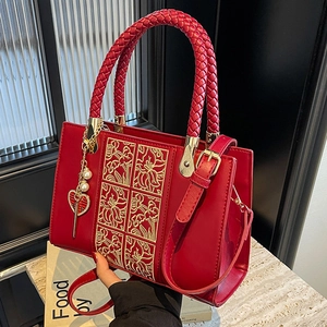Elegant red bridal handbag with golden floral embroidery and囍 charm pendant