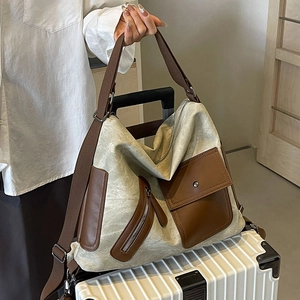Vintage canvas tote bag with brown leather details on luggage for travel and commuting