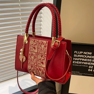 Elegant red wedding handbag with golden floral embroidery and heart pearl charm