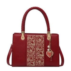 Elegant red wedding handbag with golden floral embroidery and pearl heart pendant charm