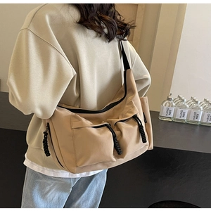 Canvas messenger bag featuring utility pockets and adjustable strap for everyday commute