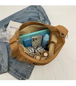 Interior view of large brown canvas tote bag showing spacious compartments and pockets