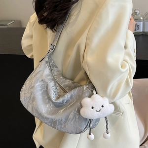 Metallic silver hobo shoulder bag with a cute white cloud plush charm and pleated texture