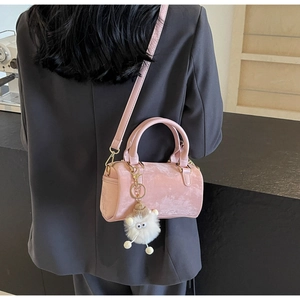 Pink velvet Boston bag with monster plush charm shown on person for fashion styling
