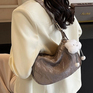 Brown pleated faux leather crescent shoulder bag with white fluffy cloud charm detail