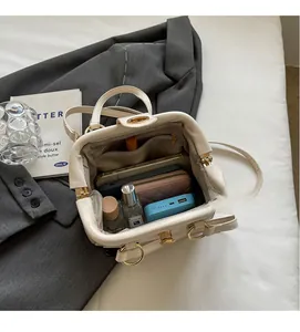 Interior view of large white Boston bag showing spacious compartments and functional pockets