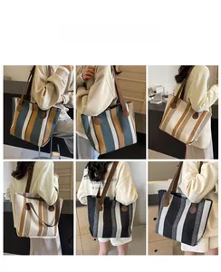 Close-up of striped canvas tote bags showing three colors and durable leather straps