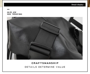 Detail showing the textured black leather finish and wide nylon strap with matte buckle