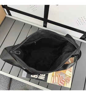 Detail view of large black canvas tote interior with zipper pocket and metal slider