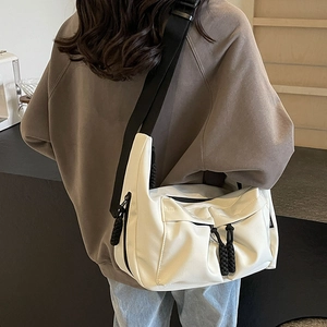 White canvas tote bag with black wide shoulder strap and braided zipper for women