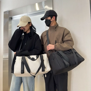 Detail showing high-capacity waterproof oxford travel bags in beige and black colors