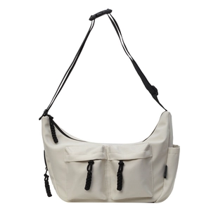 Neutral off-white canvas messenger bag with dual front pockets and black shoulder strap