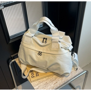 Close-up of white nylon tote bag showing durable fabric texture and dual black zippers