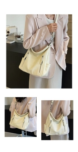 Détail de la texture cuir PU crème et des fermetures éclair argentées sur le sac fourre-tout