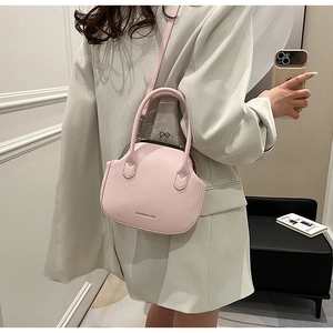 Pink leather crossbody bag with retro doctor bag frame and silver metal clasp detail